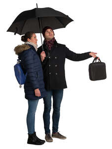 man and woman standing under the umbrella