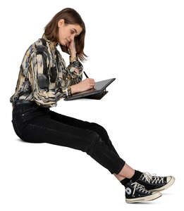 woman sitting and drawing on a graphics tablet