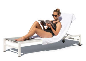 woman lying on the beach chair and reading