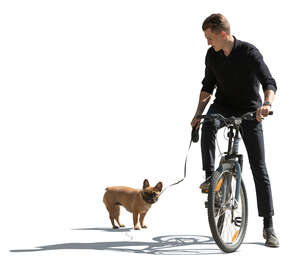 sidelit man with a dog riding a bike