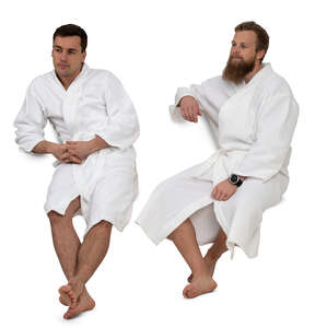 two cut out men in bathrobes sitting in a spa