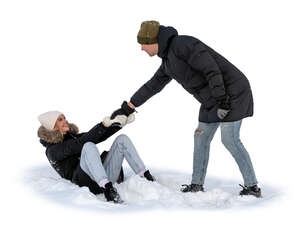 man pulling up a woman sitting in the snow