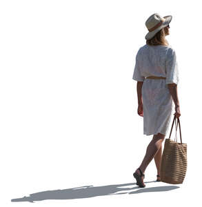 backlit woman in white summer dress walking