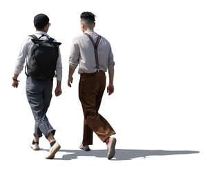two backlit stylish men walking