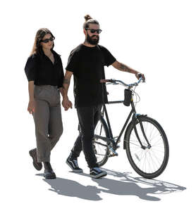 backlit couple with a bike walking hand in hand