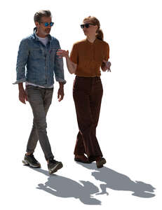 backlit man and woman walking and talking