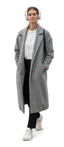 cut out woman in a grey woolen overcoat walking