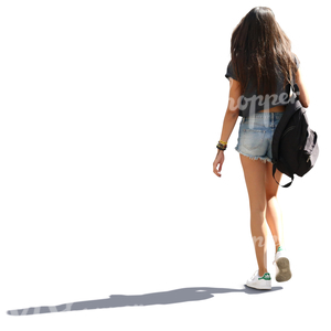backlit young woman with long hair walking down the street