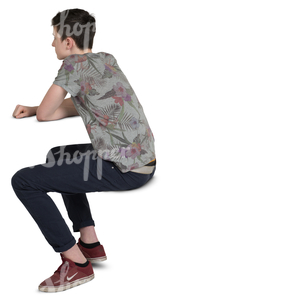 teenage boy sitting behind a table