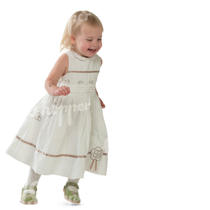 little girl in a white dress running and laughing