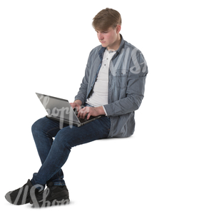young man sitting with a laptopn on his knees