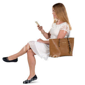 woman in a white dress sitting and texting