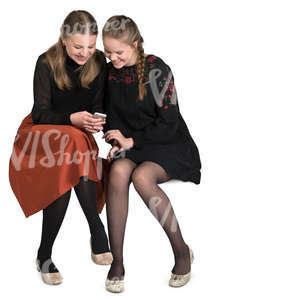 teenage girls sitting in a cafe and looking smth on the phone