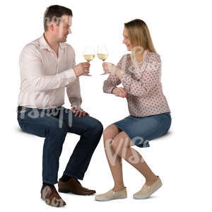 man and woman sitting in a cafe and drinking wine