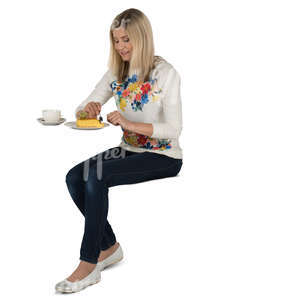woman sitting in a cafe and eating cake