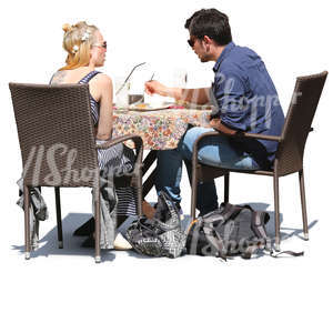 man and woman sitting in a cafe and eating