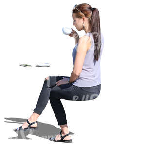 woman sitting in a cafe and drinking coffee