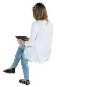 woman sitting and looking at a tablet