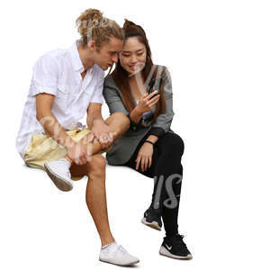 asian woman and a young mand looking smth from her phone