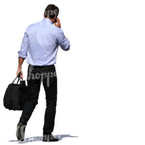 man carrying a bag and talking on a phone