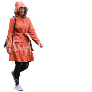 woman in an orange raincoat walking