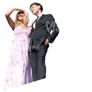 couple in party clothes standing on a balcony