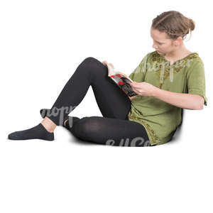 teenage girl sitting on a sofa and reading a book
