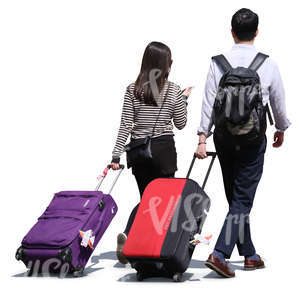 asian man and woman pulling large suitcases