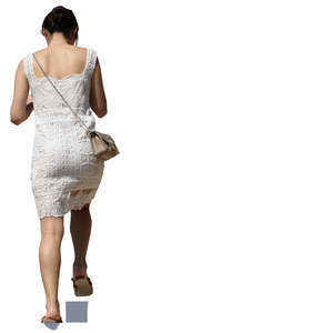woman in a white summer dress walking up the stairs
