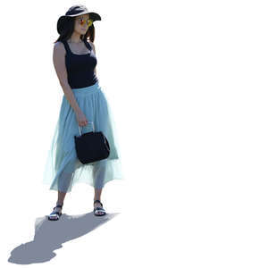 backlit woman in a light blue skirt standing