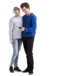 young man and woman standing and looking at a phone