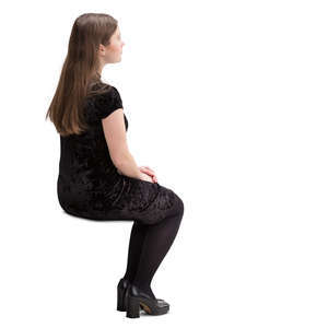 young woman in a black dress sitting