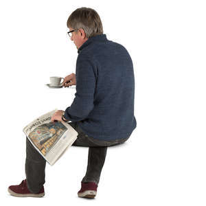 man sitting in a cafe and drinking coffee
