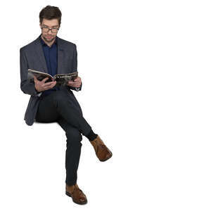 man sitting and reading a magazine
