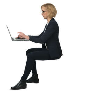 businesswoman sitting behind the desk and working on a computer