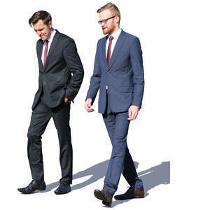 two men in suits walking and talking