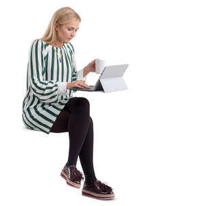 woman in a striped dress sitting behind a desk