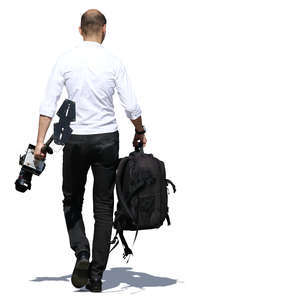 man walking and carrying camera equipment