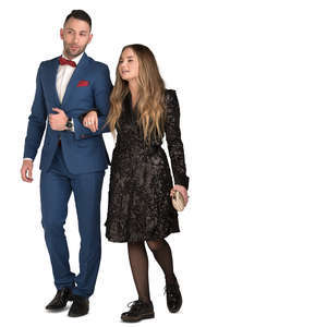 man and woman in formal clothes walking arm in arm