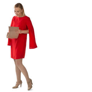 woman in a red dress standing and searching for smth in her purse