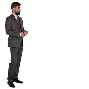 man in a grey suit standing and looking