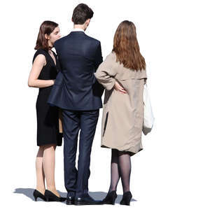 group of three people in formal clothing standing and talking
