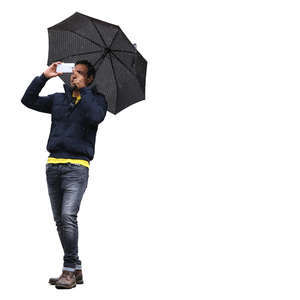 man with an umbrella taking a picture