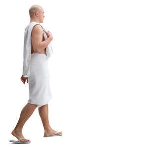 man in a towel and fliplops walking