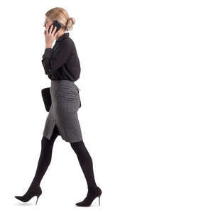 businesswoman walking and talking on a phone