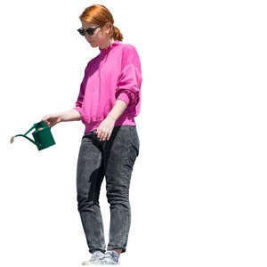 woman standing on a balcony and watering plants