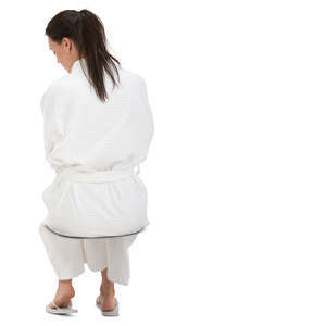woman in a white bathrobe sitting