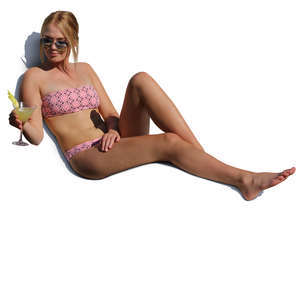 woman sitting on a beach chair and drinking cocktail
