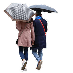 couple with umbrellas walking in the rain