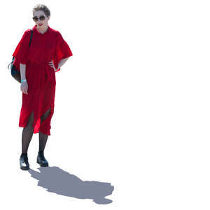 backlit woman in a red dress standing